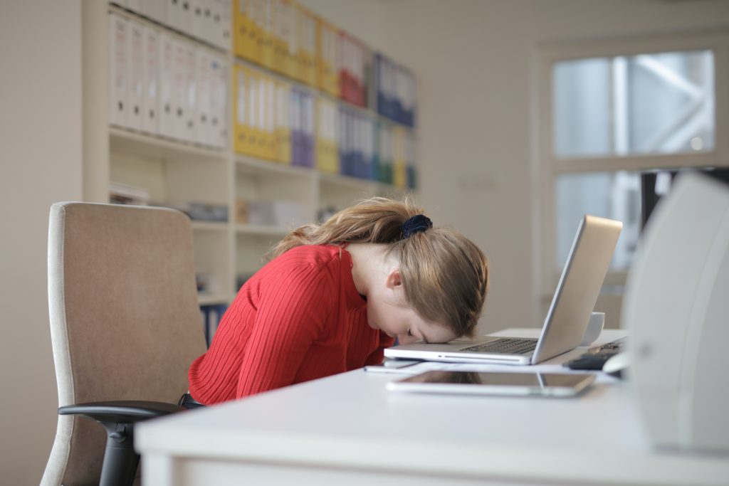 Teacher with head on laptop