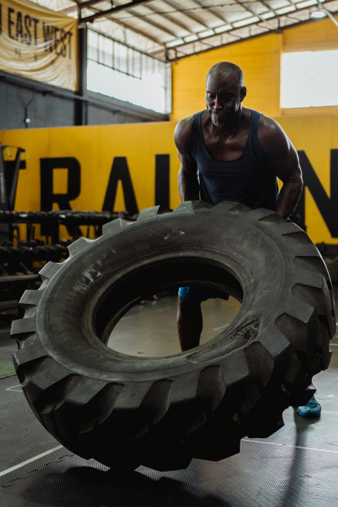 Man moving a tyre