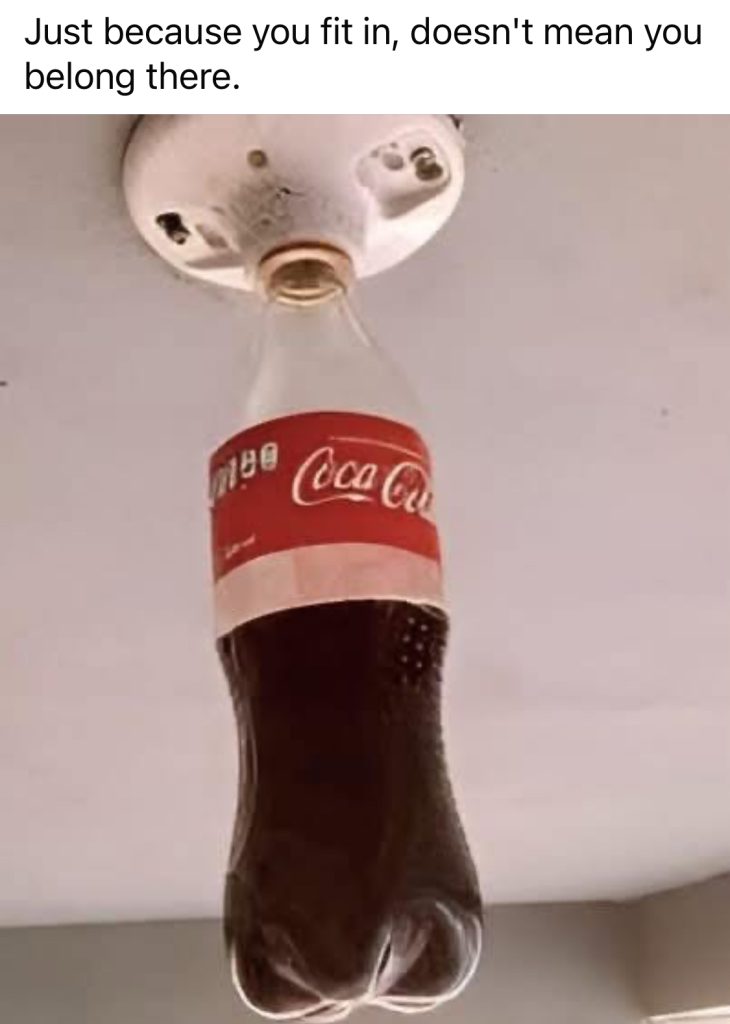 Coke bottle screwed into a light fitting.